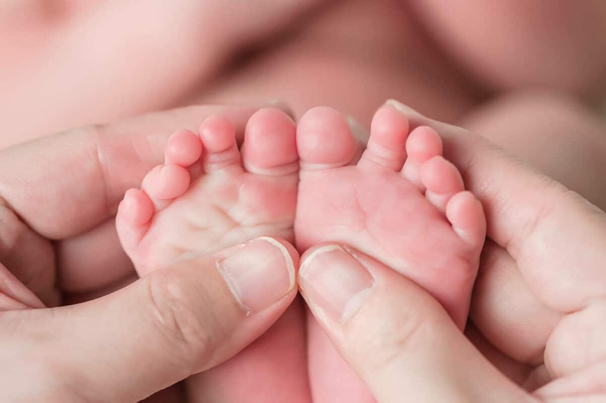 Newborn Feet in Hands Eden Bao