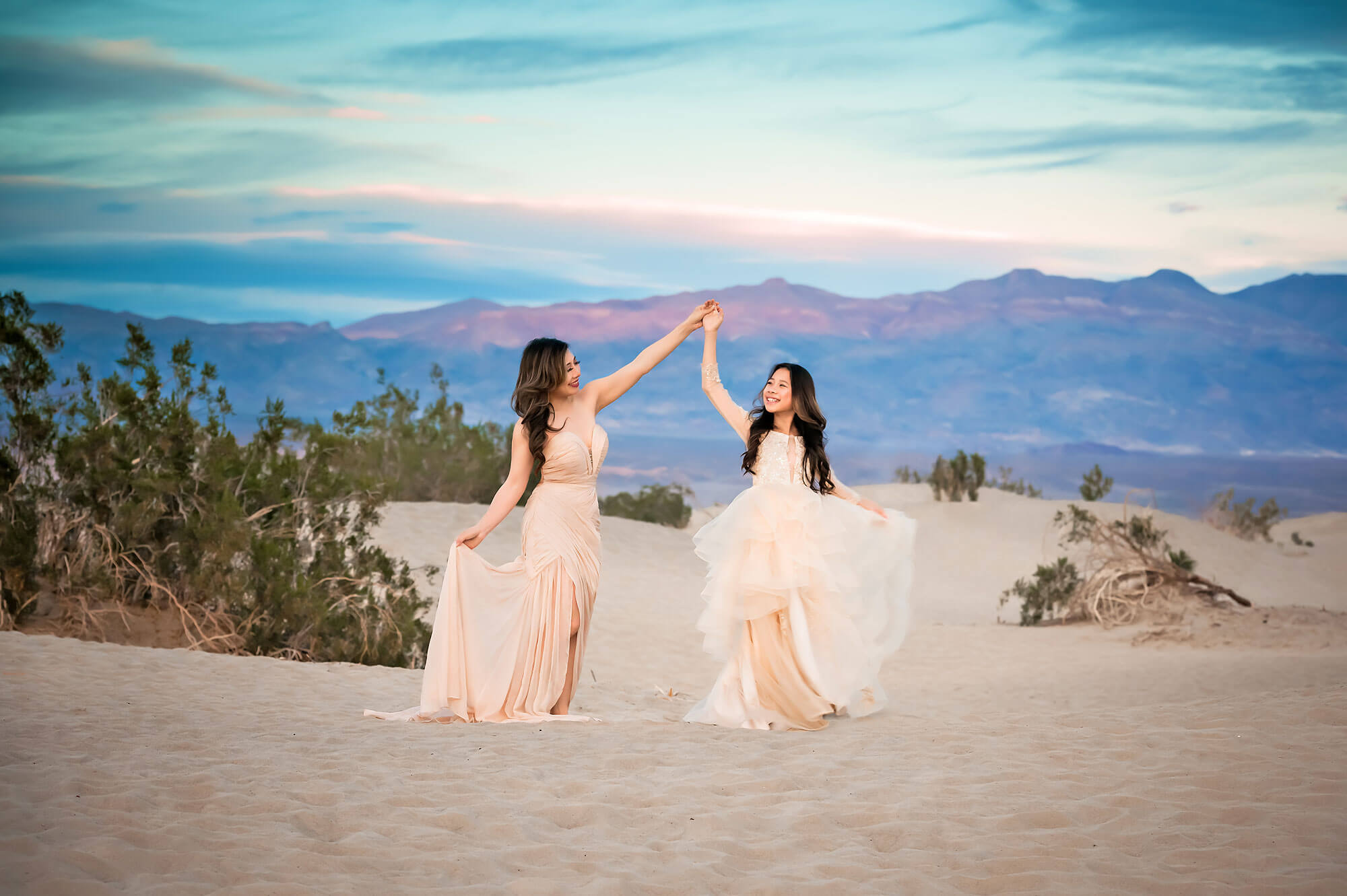 Mom and daughter dancing at Mesquite Flat Sand Dune Death Valley for Family Photographer